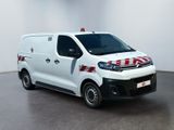 the white van is parked in a large room with a red and white stripe on the side