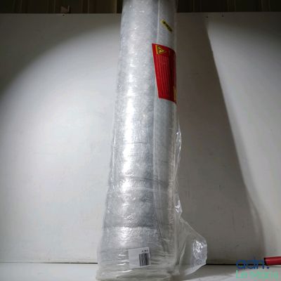 a large roll of plastic wrapped up on the floor