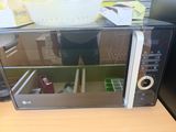 a microwave that is sitting on a table in the kitchen