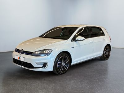a white volkswagen golf is parked in a white room
