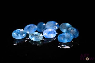 de très jolies pierres précieuses bleues sur un fond noir