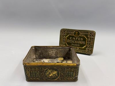 pair of antique brass money boxes with coins in them on a white background