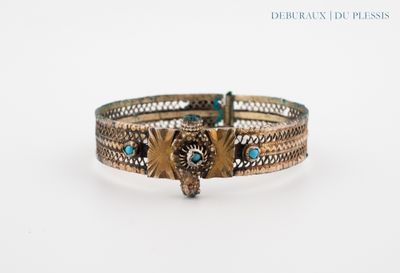 a close up of a bracelet with an owl on it