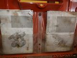 two pieces of paper on the back of a red truck