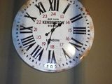 a large clock hanging on the wall in the room