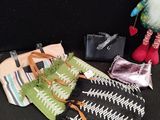 a small bag and a small purse on a black surface