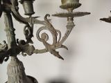 a close up of a chandelier with candles on it