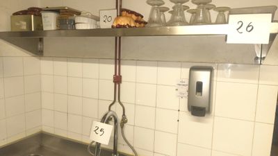 a sink in a kitchen with a lot of dishes on it