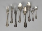 a lot of silver spoons and forks on the table