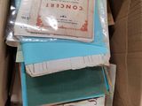 a cardboard box full of books and papers on the floor