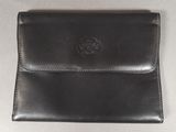 leather wallet with a coin inside on a white surface