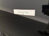 a man standing next to a car with a sticker on it