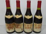 four bottles of wine are lined up on a table