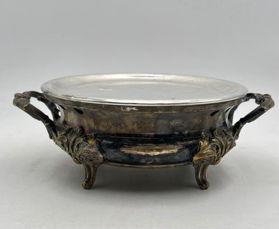 an antique silverplated bowl with handles and handles on a stand