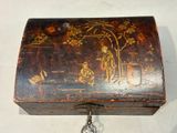 a small wooden box with a painting on it