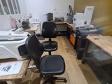 a desk with a chair and a computer on it