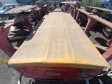 a yellow surfboard sitting on top of a red cart