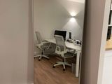 un miroir dans un coin d'une pièce où se trouvent un bureau et une chaise
