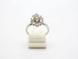 a close up of a diamond ring on a white surface