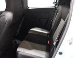the back seats of a white car with a black seat belt