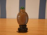 a small glass bottle sitting on a wooden table