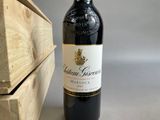 a bottle of wine sitting next to a wooden box