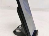 a cell phone that is on a stand on the table