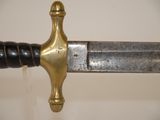 a close up of a sword with a black handle