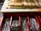 a lot of silverware in a drawer on the table