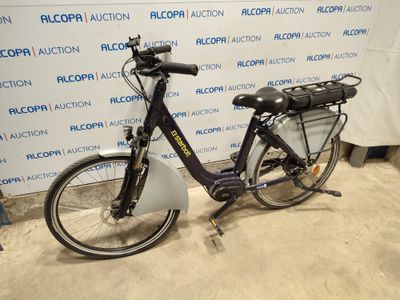 a bike that is parked in front of a wall