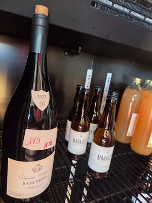 bottles of wine are lined up on a shelf in a wine cellar