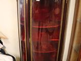 a glass display cabinet in a corner of a room