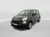 the small black car is parked in a white room