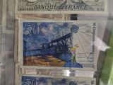 five different bank notes in a clear plastic case