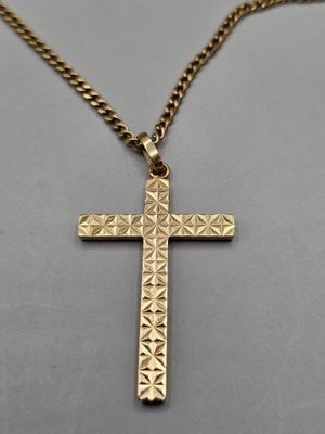 a gold cross pendant on a gold chain