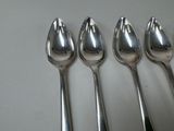 five spoons that are sitting on a table