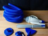 a close up of a blue hose, a pipe, and other items on a wooden table