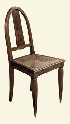 a wooden chair with a wicker seat on a white background