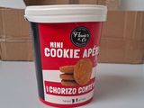 a cup of ice cream sitting on a table next to a box of cookies