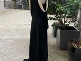 a black dress on a mannequin stand in a courtyard