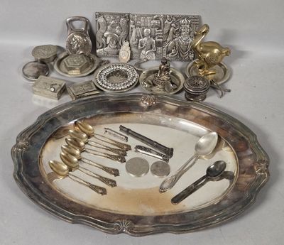 a silver plate with silverware on it on a table