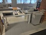 a desk with a printer and a printer on it in a room