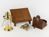 a small wooden table with a lamp and other items on it