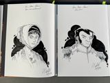 three books with drawings of people on them on a table
