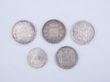four different coins are shown on a white surface
