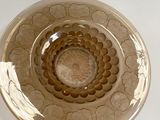 a glass bowl that has a flower design on it