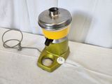 a yellow and silver blender sitting on a white table