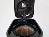 a black toaster that is on top of a table
