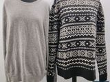 two women ' s sweaters on mannequins on display in front of a white background