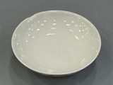 a white bowl sitting on top of a table